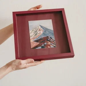 plum coloured square frame with mountain pastel drawing