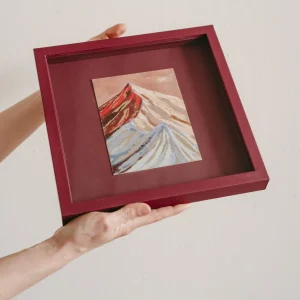 plum coloured square framed pastel study of a colourful mountain