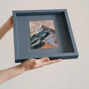 blue coloured square framed pastel study of a colourful mountain