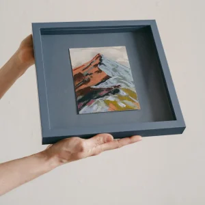 Blue coloured square framed pastel study of a colourful mountain