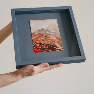 blue coloured square framed pastel study of a colourful mountain