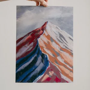 Rose and blue hues of a soft pastel drawing of a mountain peak