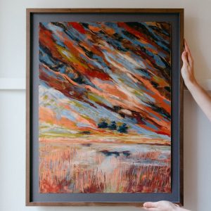 Framed abstract landscape painting in soft pastels. Fire colours vivid light capturing reflections on the water
